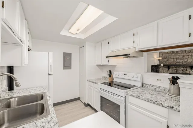 a kitchen with granite countertop a sink stainless steel appliances and cabinets
