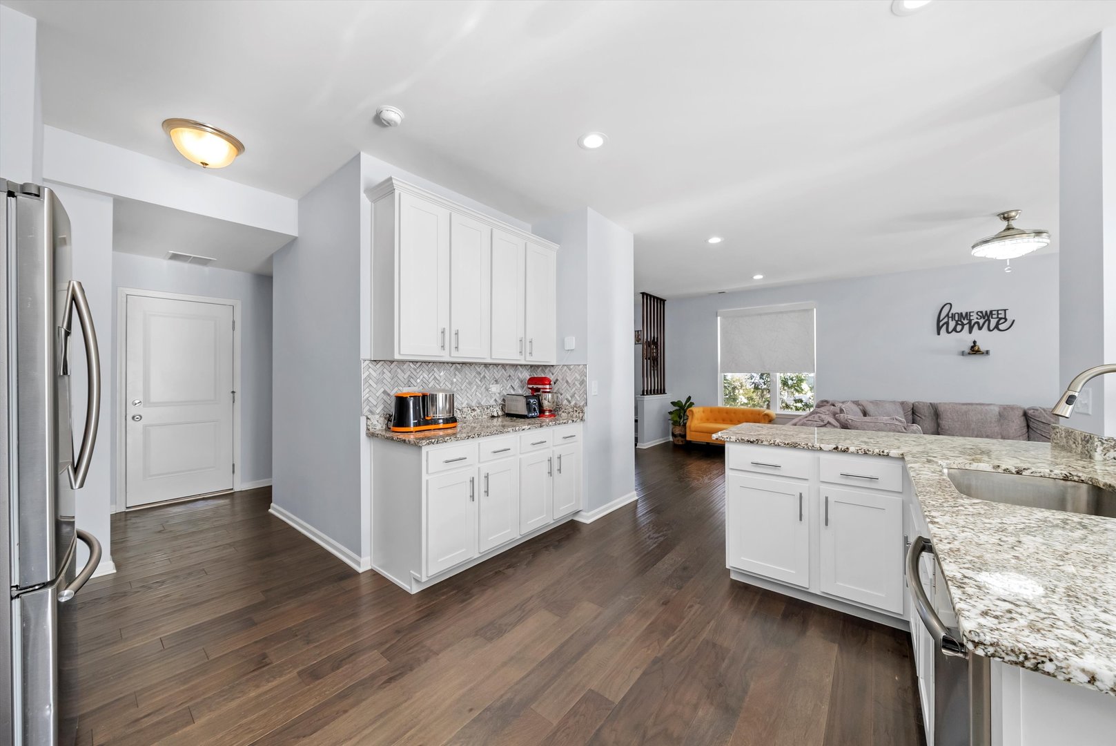 4177 Irving Road Aurora, IL 60504 - Photo 15 of 39 a kitchen with white cabinets and wooden floor