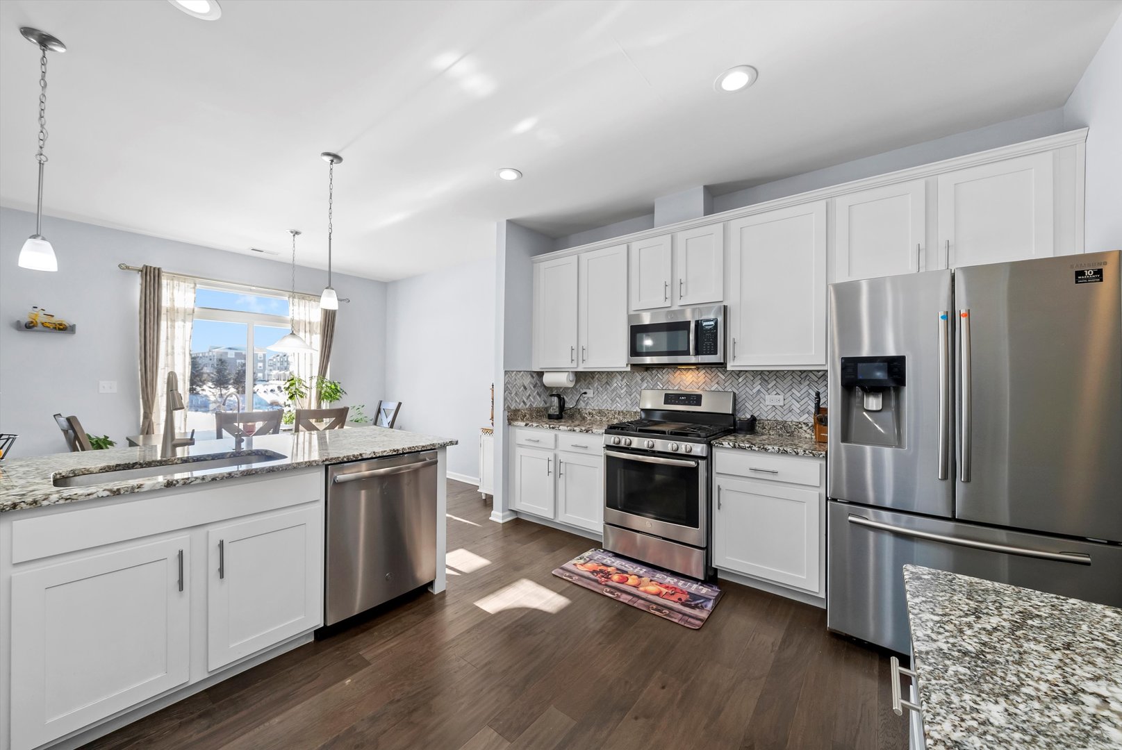 4177 Irving Road Aurora, IL 60504 - Photo 16 of 39 a kitchen with white cabinets and stainless steel appliances