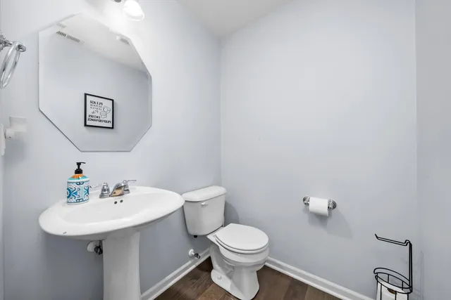 a bathroom with a sink toilet and a mirror