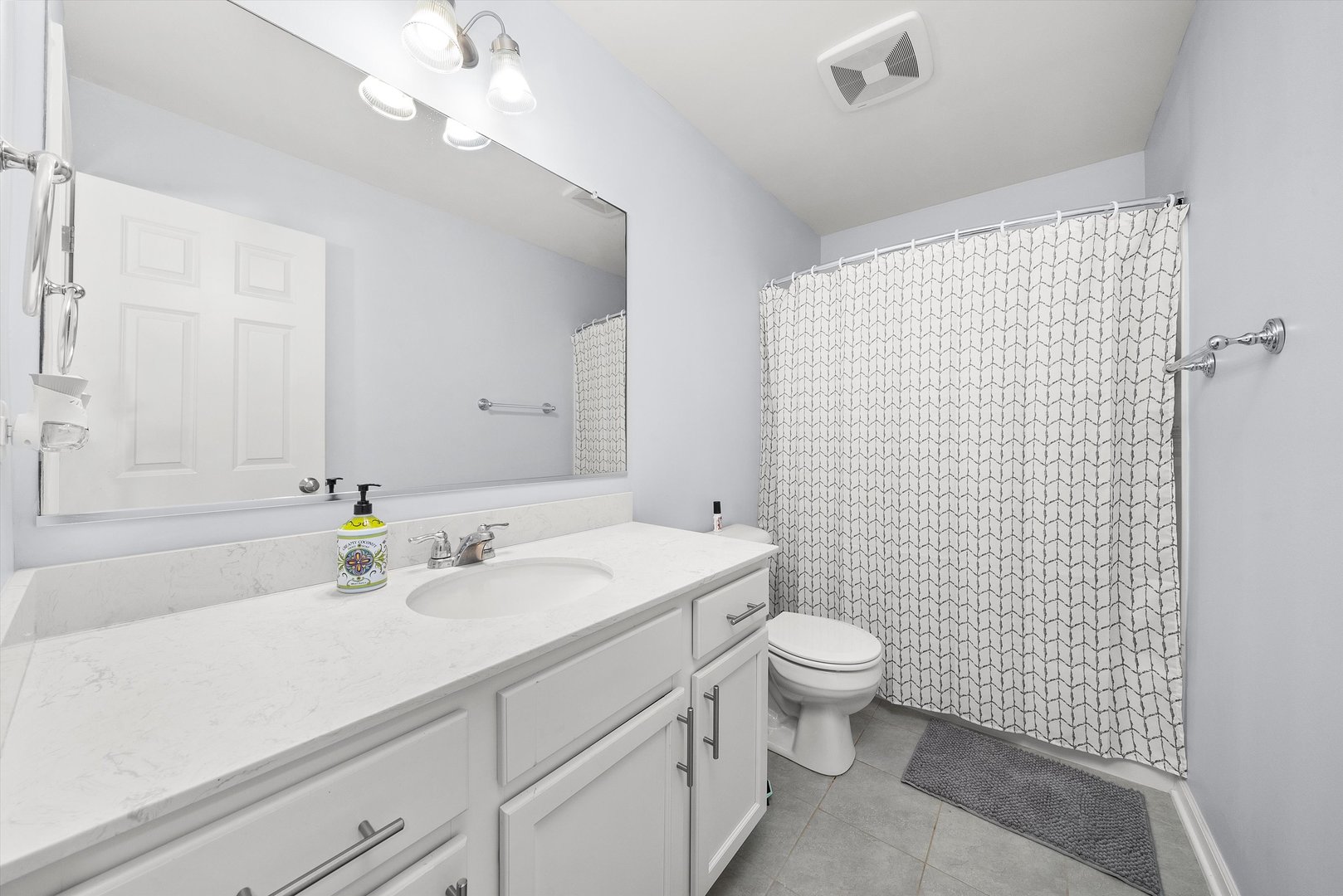 4177 Irving Road Aurora, IL 60504 - Photo 27 of 39 a bathroom with a sink a toilet and shower curtain