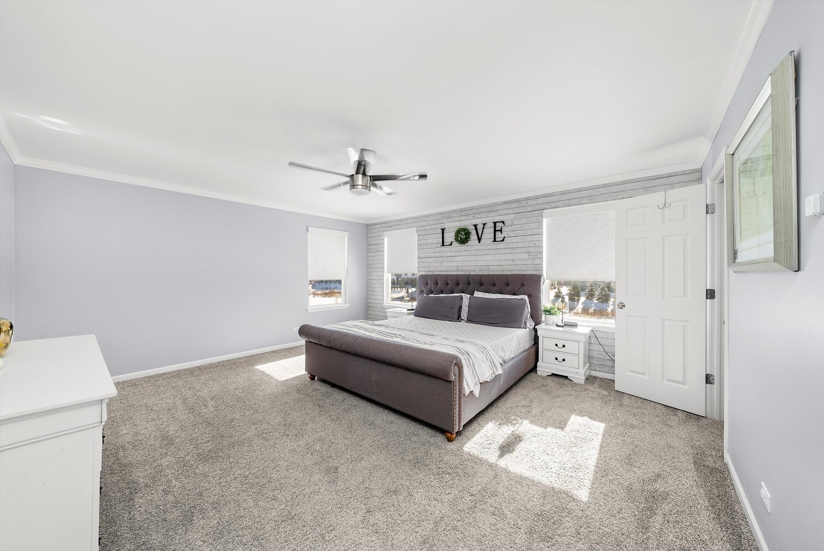 4177 Irving Road Aurora, IL 60504 - Photo 28 of 39 a spacious bedroom with a bed and a chandelier