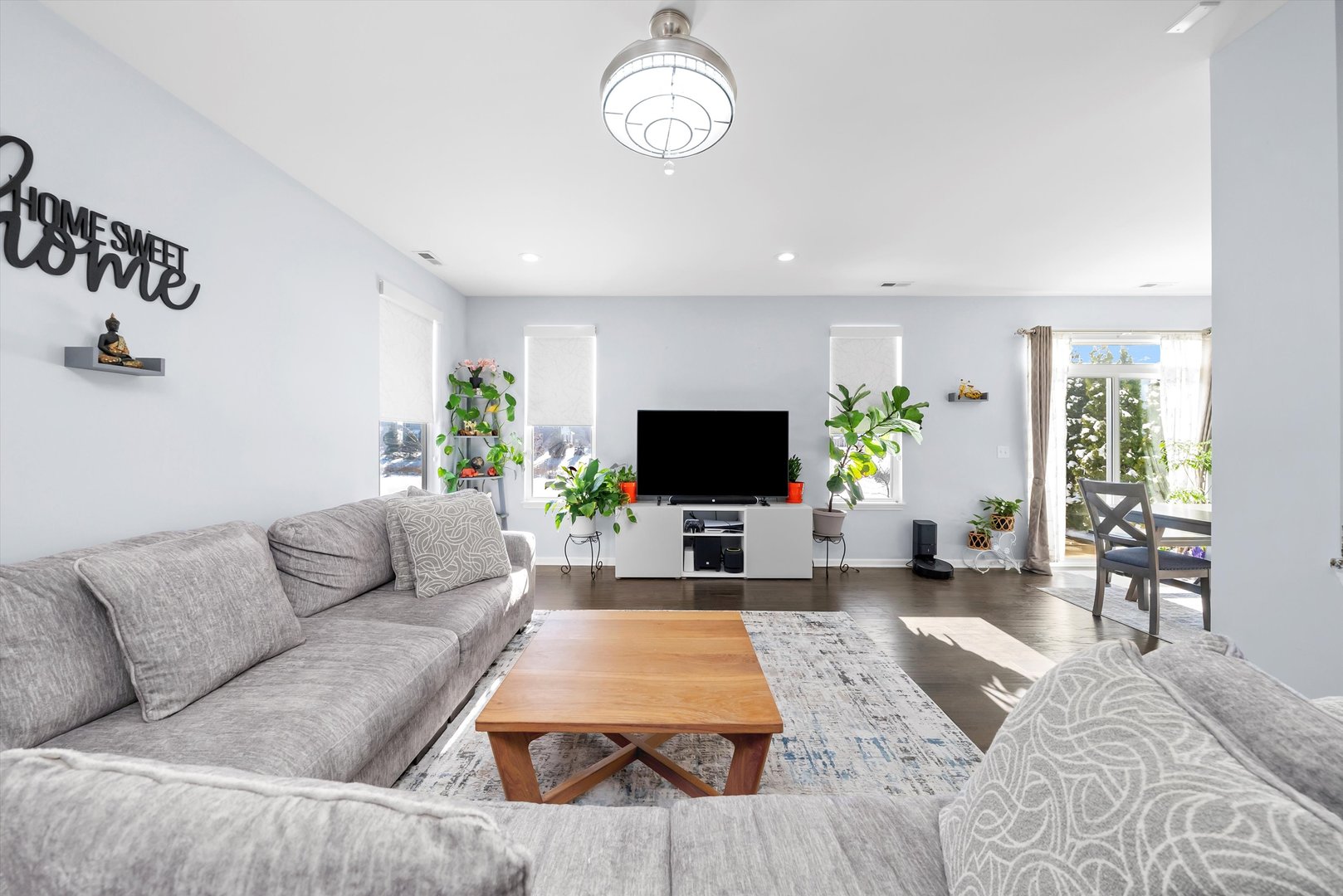 4177 Irving Road Aurora, IL 60504 - Photo 7 of 39 a living room with furniture a flat screen tv and a large window