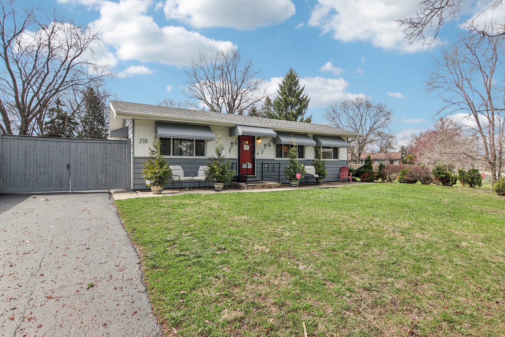 238 West Frontage Road Northfield, IL 60093 - Photo 1 of 16 a front view of a house with garden