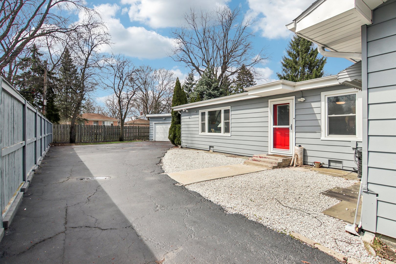 238 West Frontage Road Northfield, IL 60093 - Photo 12 of 16 a backyard of a house with wooden fence and large trees