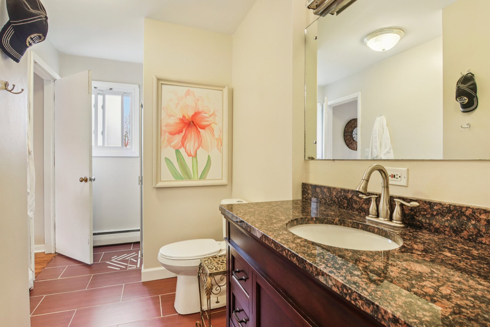 238 West Frontage Road Northfield, IL 60093 - Photo 7 of 16 a bathroom with a granite countertop sink a toilet and a mirror