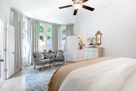 a bedroom with a bed couch and a window