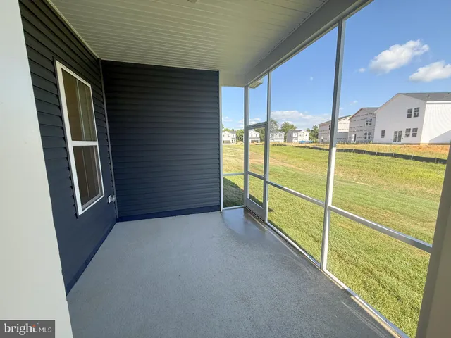 a front view of a house with a yard and potted plants