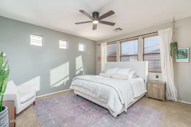 a bedroom with a bed and a window