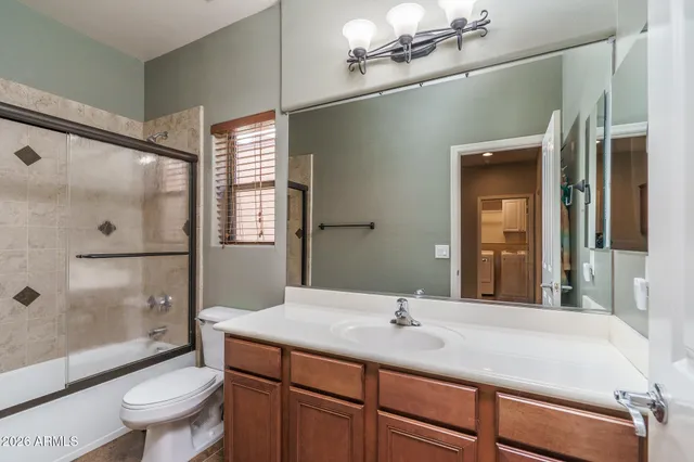 a view of a swimming pool with lawn chairs under an umbrella