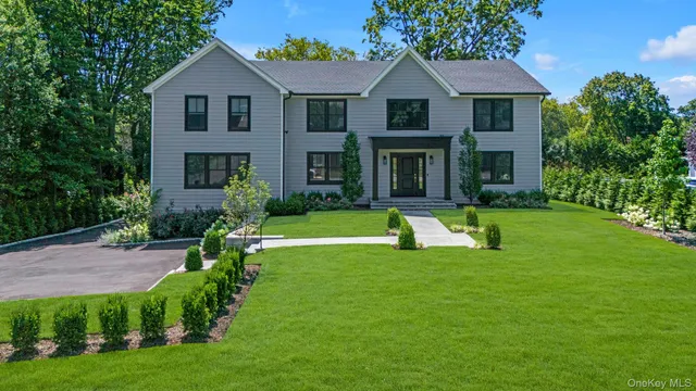 a view of house with a yard and porch