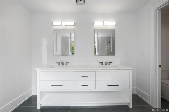 a bathroom with double vanity sink a mirror and vanity