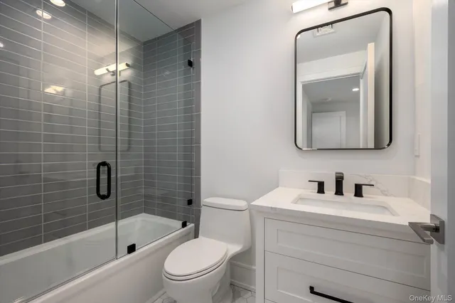 a bathroom with a toilet a sink a bath tub and shower