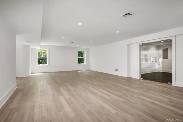 a view of empty room with wooden floor