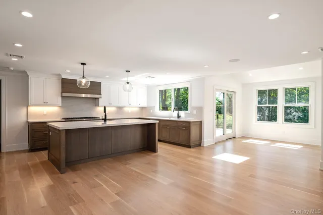 a large kitchen with stainless steel appliances kitchen island granite countertop a large counter top and outdoor space