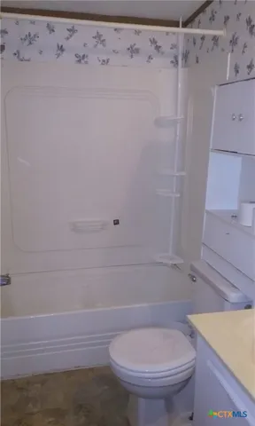 a bathroom with a toilet and a shower
