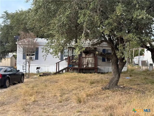 a view of a house with a yard covered in snow
