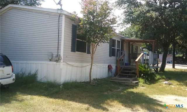 a view of house with backyard