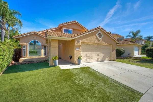 a front view of a house with a garden and yard