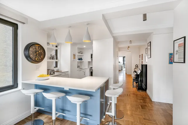 a view of a dining room with furniture and a clock
