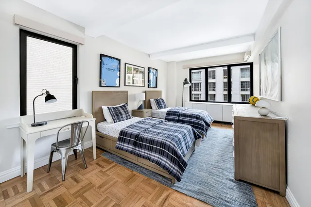 a bedroom with a bed and a night stand