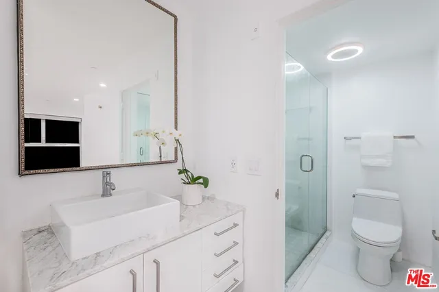 a bathroom with a sink toilet a shower and a mirror