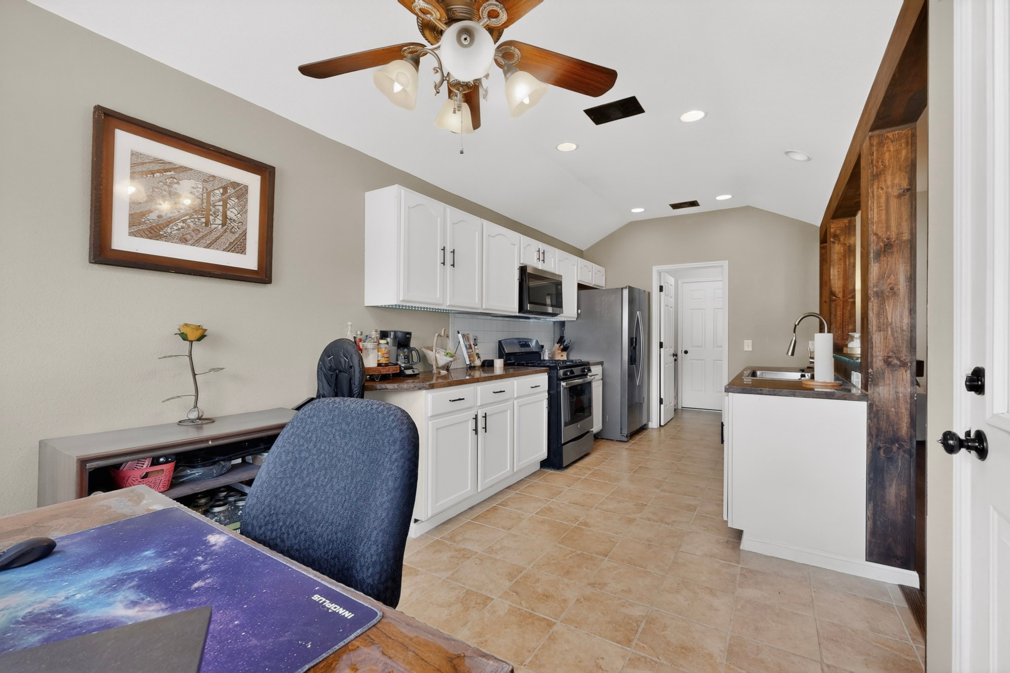 15104 Mimebark Way Austin, TX 78724 - Photo 15 of 38 Kitchen area featuring vaulted ceilings, recessed lighting, and tile flooring