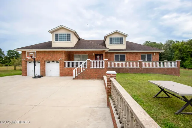 a front view of house with yard and green space
