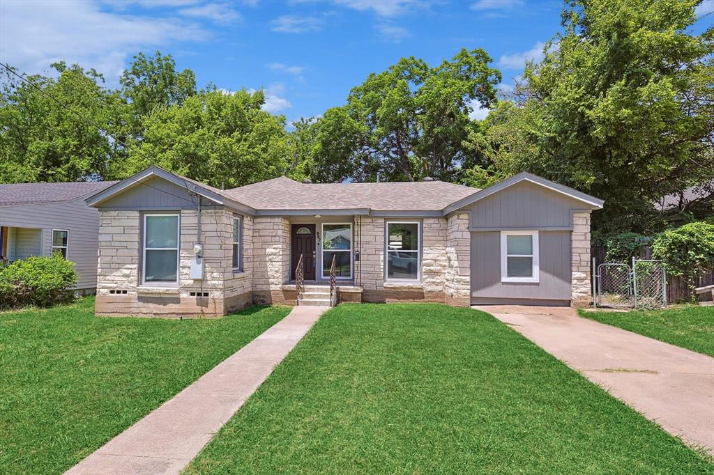 a front view of a house with a yard and porch