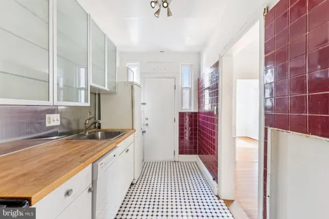 a bathroom with a granite countertop sink a toilet and a shower