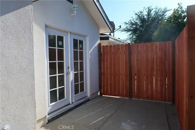 a view of wooden door in front of house