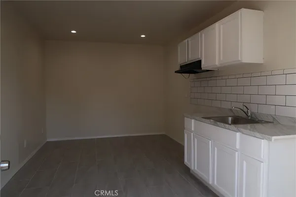 a kitchen with a sink and cabinets