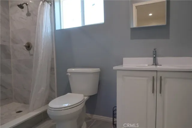 a white toilet sitting next to a bathroom sink