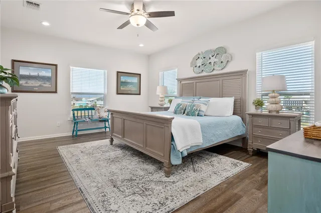 a bedroom with a bed wooden floor and window