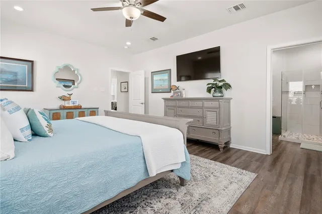 a bedroom with a large bed and flat tv