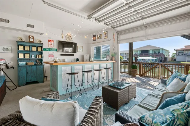 a living room with furniture a flat screen tv and a table