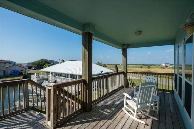 a view of balcony with wooden floor and seating space