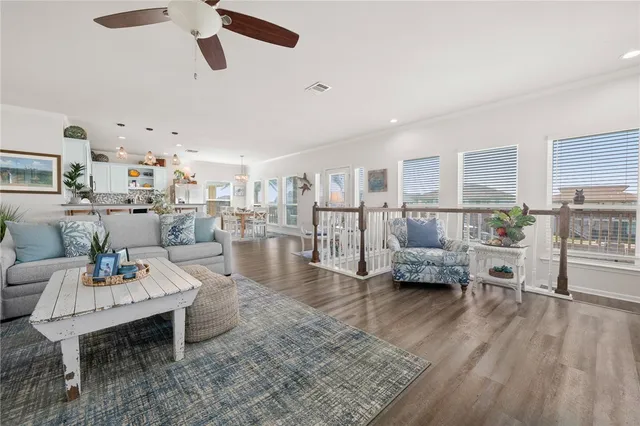 a living room with lots of furniture and a wooden floor
