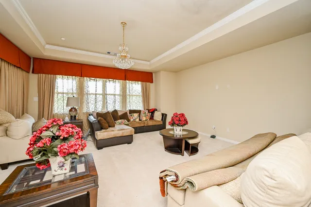 a living room with furniture and a floor to ceiling window