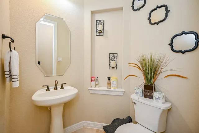 a bathroom with a sink a mirror and a toilet