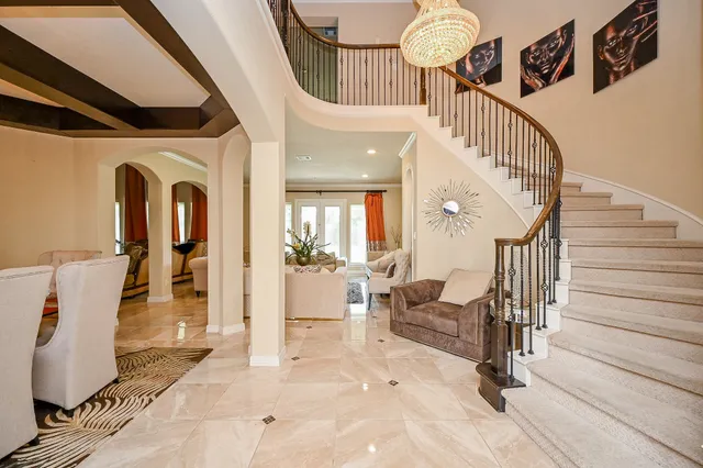 a view of a hallway with dining area and chandelier