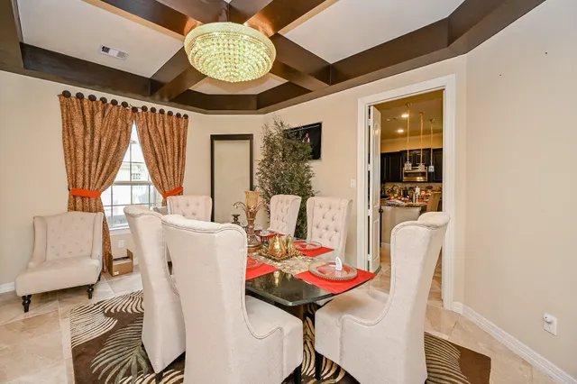 a view of a dining room with furniture and window