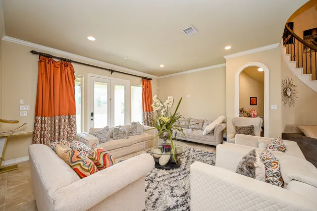 a living room with furniture and a large window