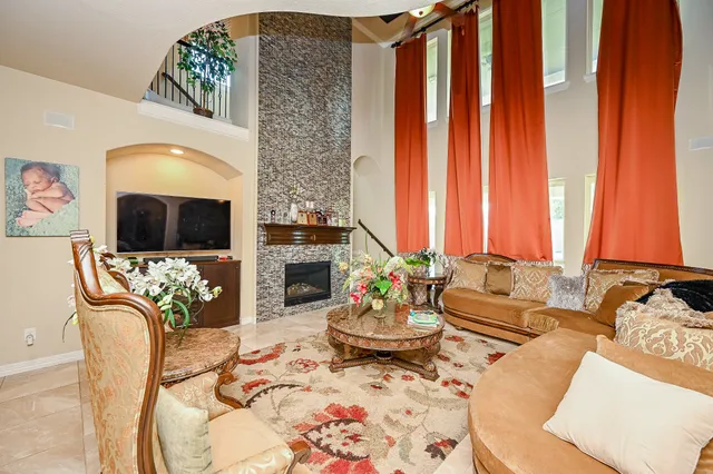 a living room with furniture fireplace and flat screen tv