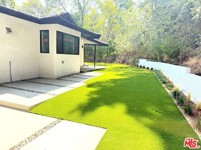 a view of a backyard with swimming pool