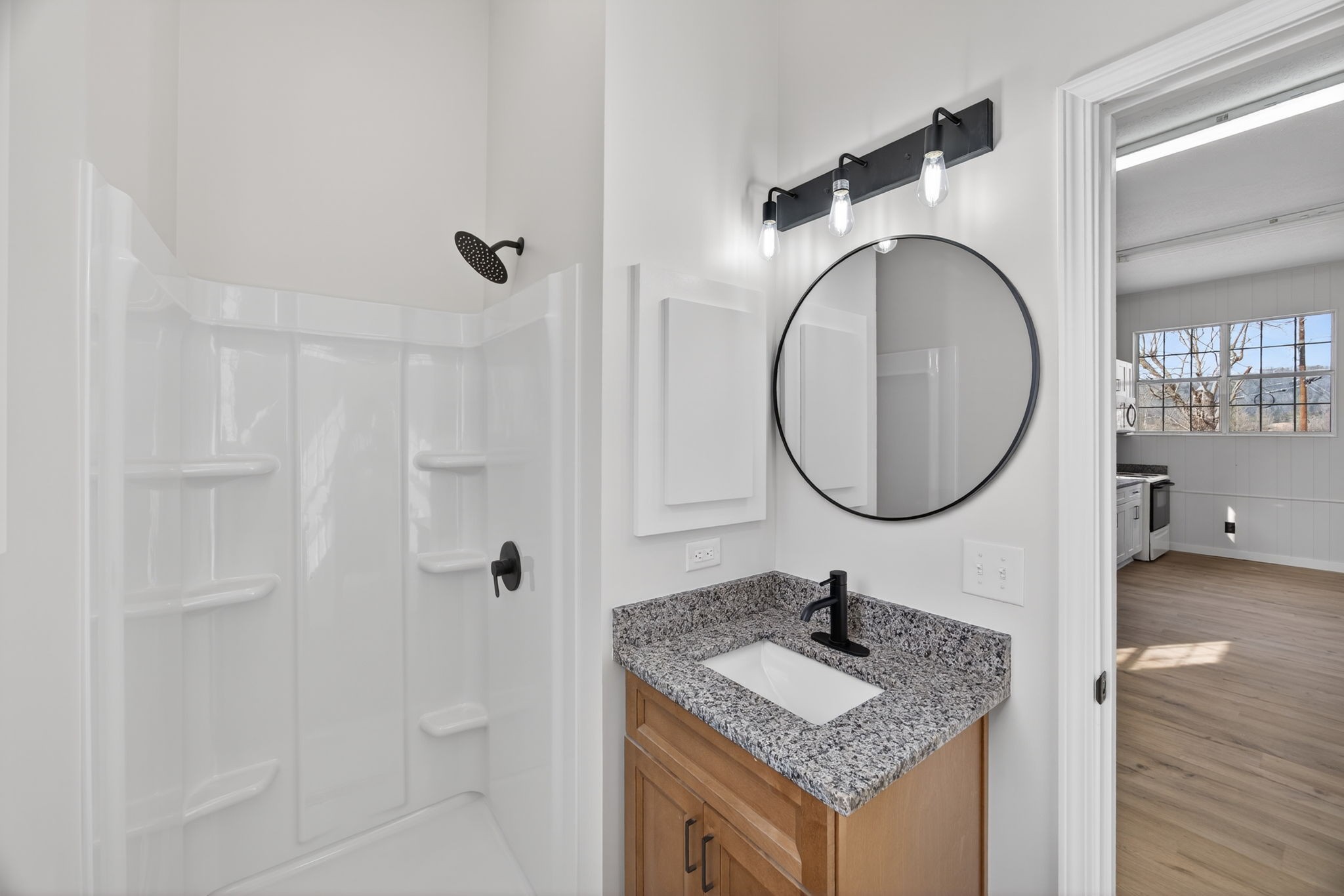 461 Baker Mountain Road Sparta, TN 38583 - Photo 37 of 43 a bathroom with a granite countertop sink a mirror and shower