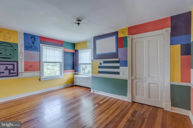 a spacious bedroom with a bed and a window