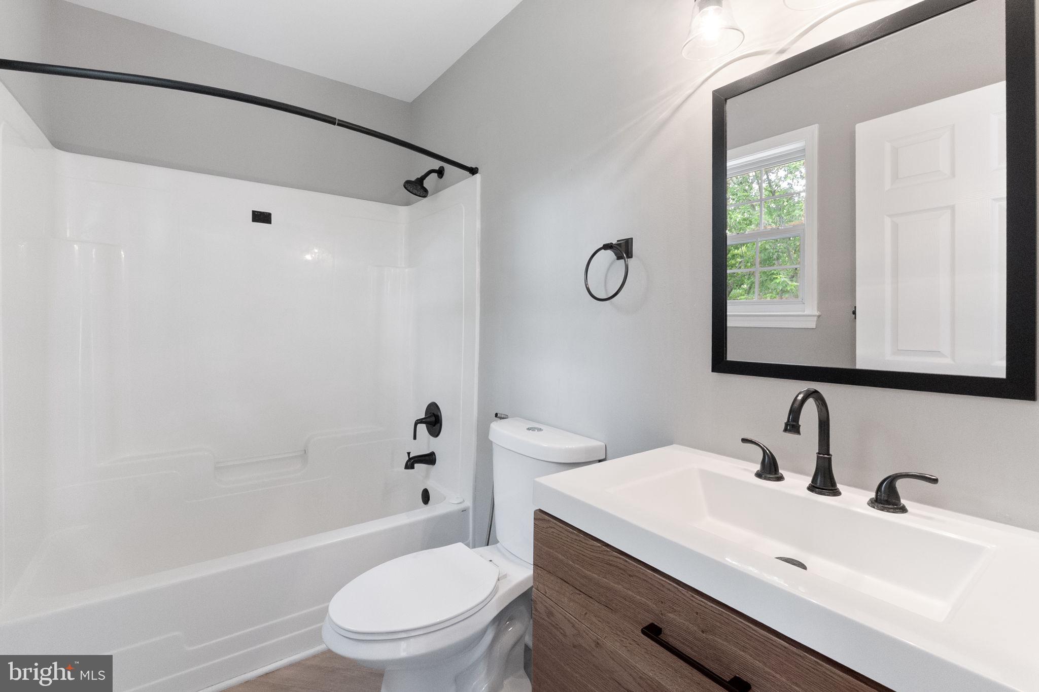 1527 Lincoln Road Shady Side, MD 20764 - Photo 18 of 30 a bathroom with a sink toilet and shower
