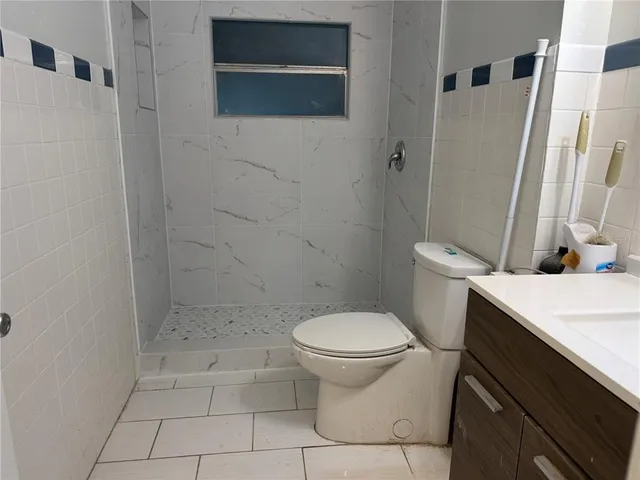 a white toilet sitting next to a bathroom sink