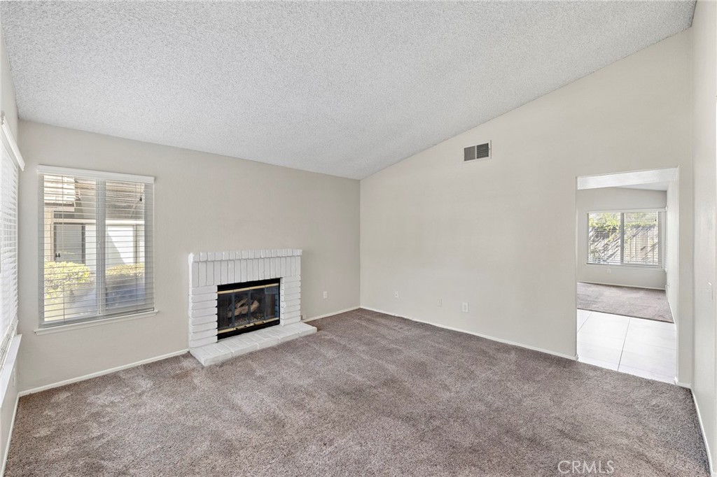 5050 Canyon Crest Drive, Unit 7 Riverside, CA 92507 - Photo 9 of 44 Living room with fireplace